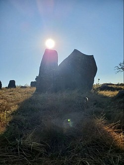 The sun's alignment above the male stone during a solstice at Adam's Calendar.